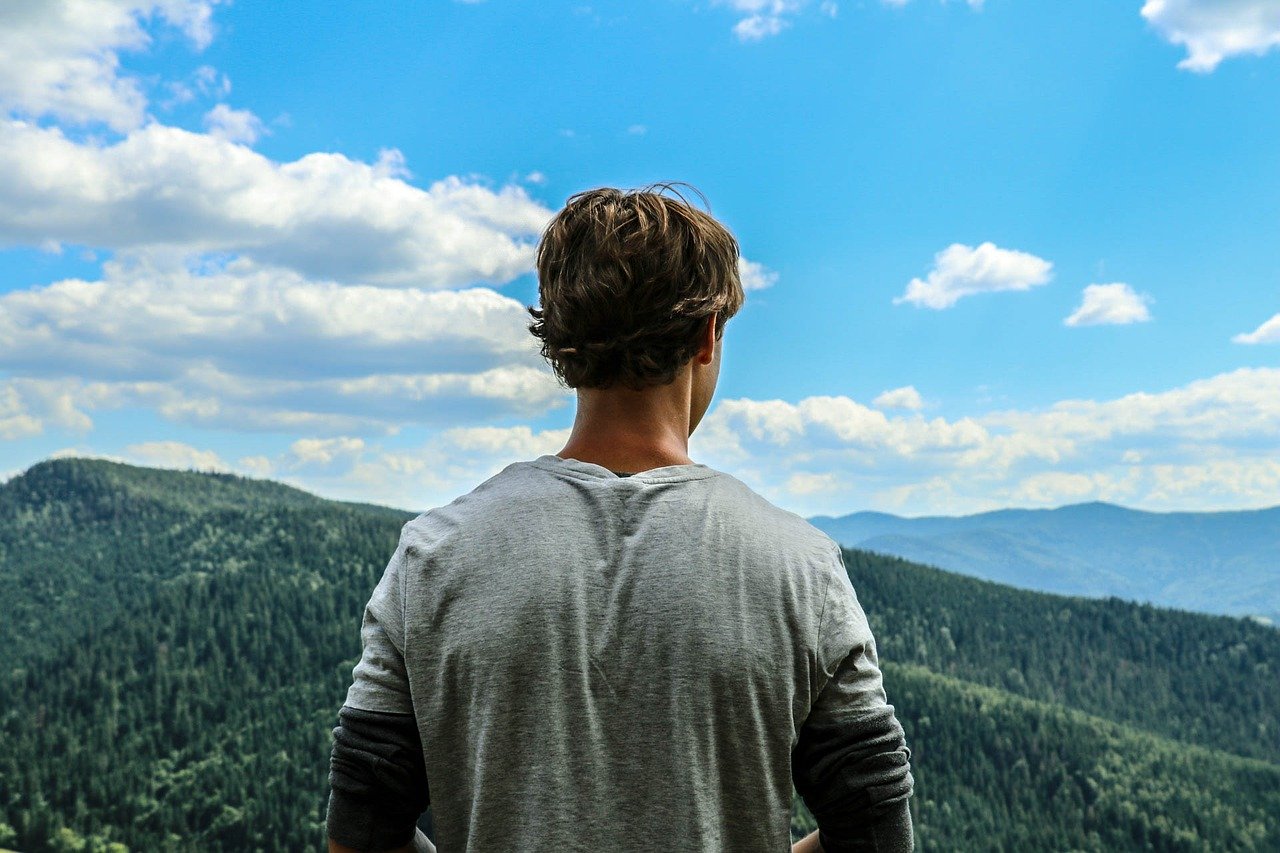 young man looking over mountains