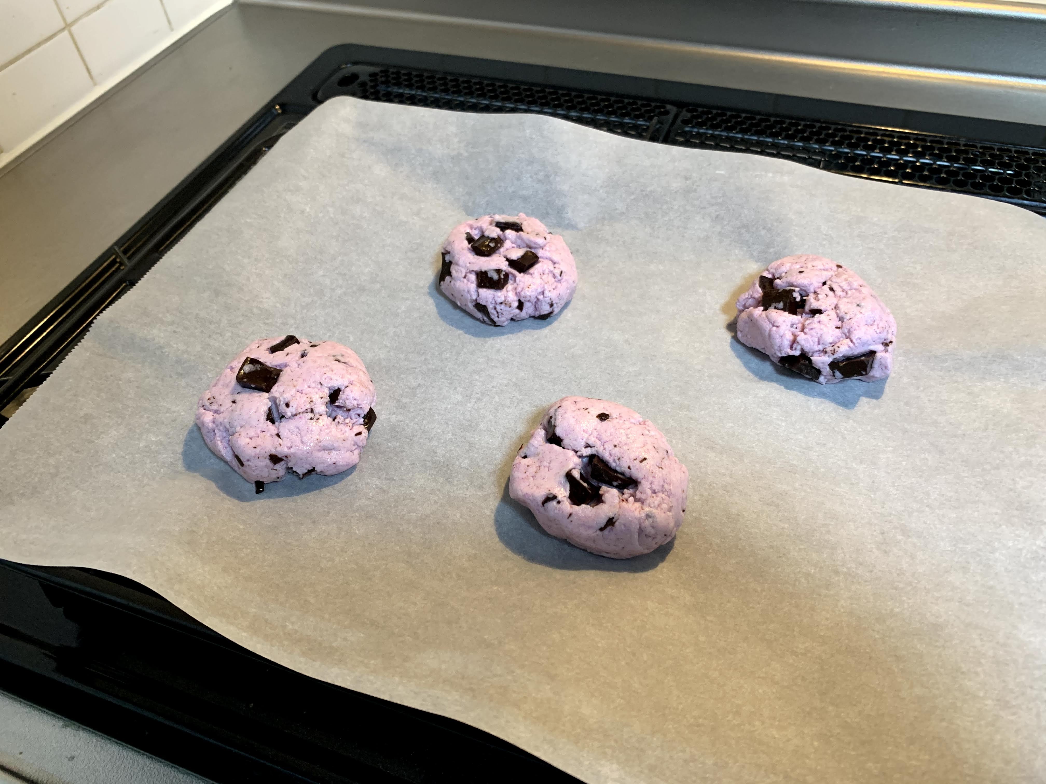 baking sheet with pink biscuits