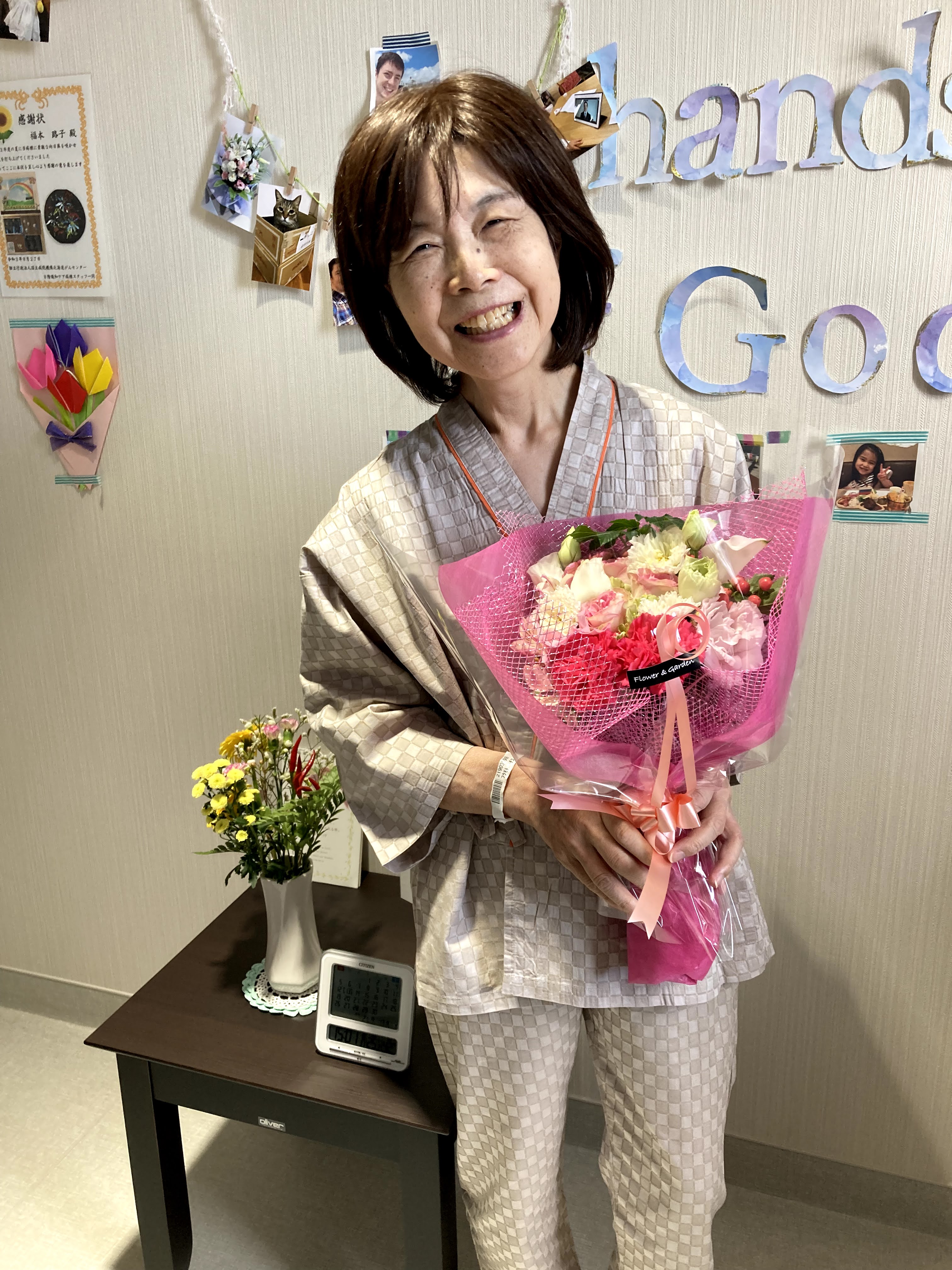 Mum holding a bunch of flowers on her birthday at the hospital