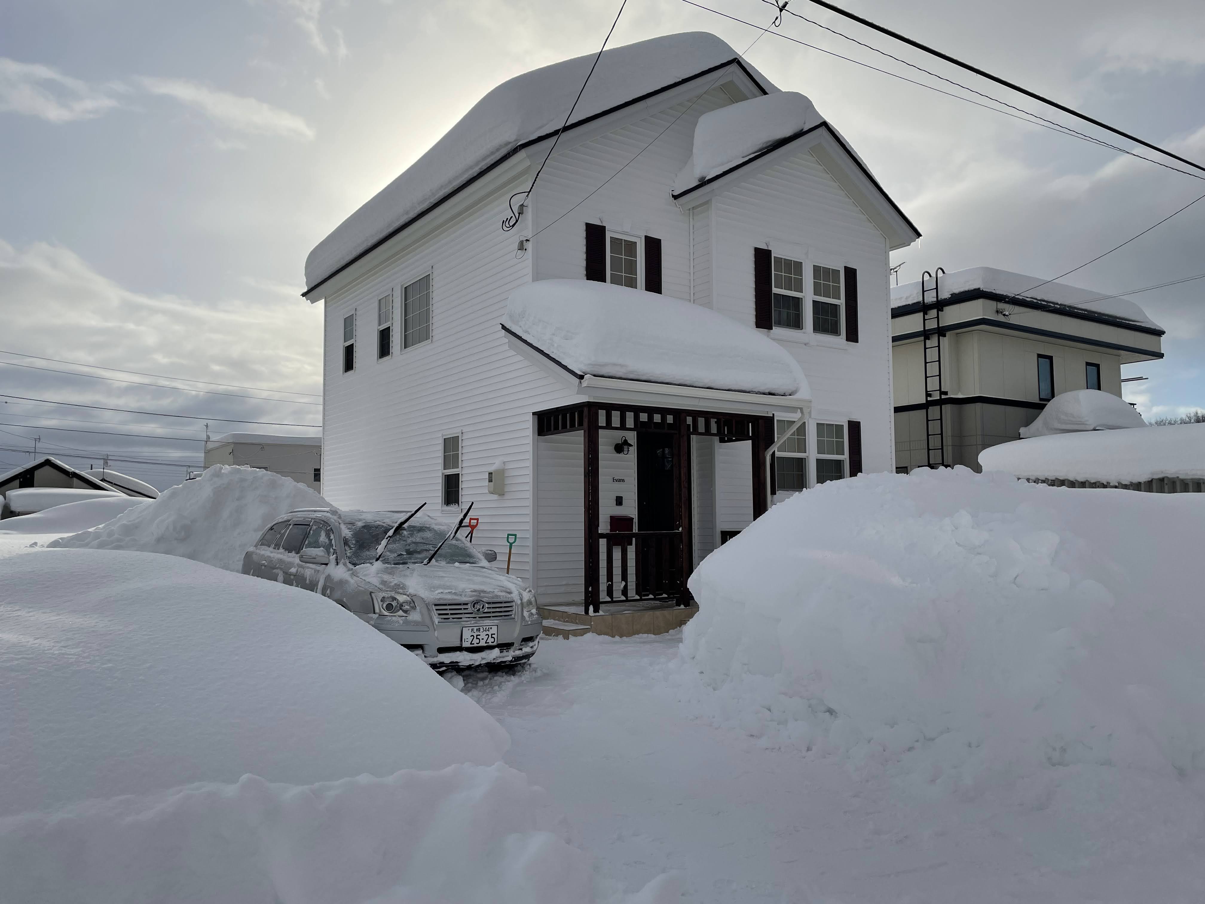 front porch of house covered in record-breaking amounts of snow